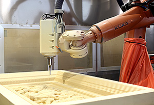 The KR QUANTEC extra HA milling one of the test pieces made of foam